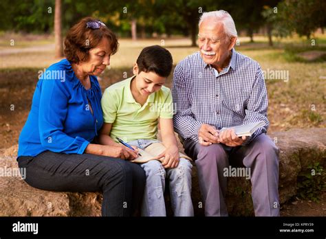 Grandpa And Grandma Helping Boy With Homework Stock Photo Alamy