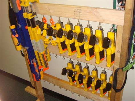 Now take out all of your airsoft guns, nerf guns, foam swords, minecraft pickaxes, and whatever else you would like to hang and start to add it. Another Nerf rack idea | DIY Furniture & Storage ...