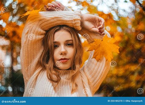 Photo Portrait Of A Girl In A White Sweater The Blonde Holds Leaves In