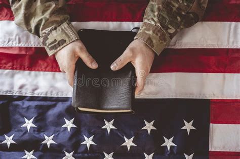 American Soldier Mourning And Praying With The Bible In His Hands And