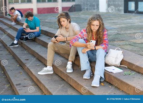Teenagers With Smartphones Sitting On Stairs Stock Photo Image Of