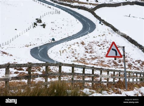 Snow Twisting Road Commondale Moor North Yorkshire England Stock Photo