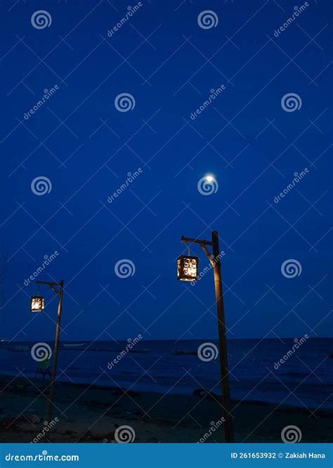 The Atmosphere Of The Beach At Night With The Lights And The Moonï¿¼