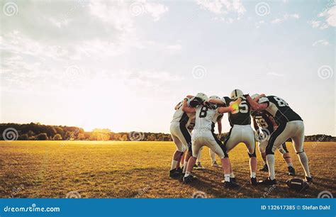 American Football Players In A Huddle During Practice Stock Image