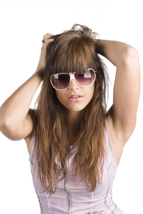 Free Photo Portrait Of Woman Wearing Sunglasses Standing Against White