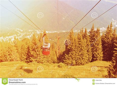 A Toned Picture Of Bright Red Cableway Cabin Moving To The Top O Stock Photo Image Of Cableway