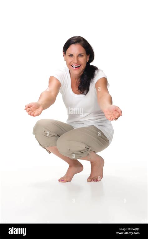 A Portrait Of An Attractive Cheerful Mom Kneeling Down With Arms Outstretched As If Gesturing