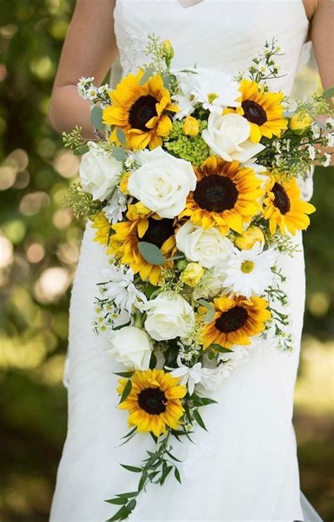 A Bride Holding A Bouquet Of Sunflowers And White Roses On Her Wedding Day