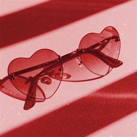 A Pair Of Heart Shaped Glasses Sitting On Top Of A Table