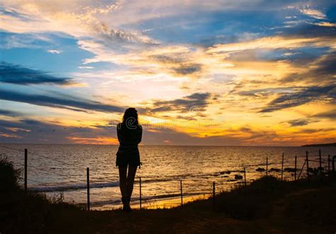 Silhouette Of Woman Stands At The Beach On Sunset Stock Image Image