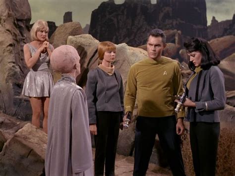 The Star Trek Crew Is Talking To Each Other In Front Of Some Rocks And