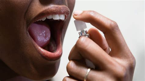 Woman Sprays Breath Freshener In Her Mouth