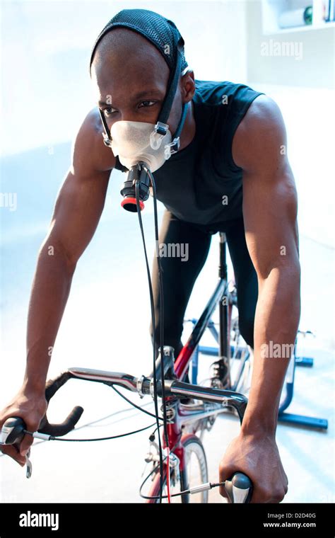 Model Released Performance Testing Athlete Riding An Exercise Bike While His Performance And
