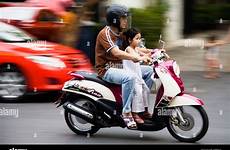 motorcycle father daughter taxis coloured brightly pass alamy young
