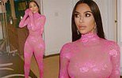 kim kardashian shows off her hourglass curves in a sheer lace pink bodysuit