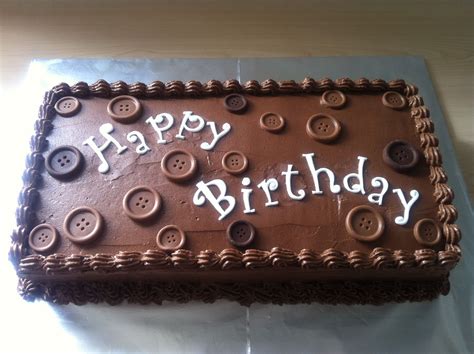 A Chocolate Birthday Cake With Buttons On It