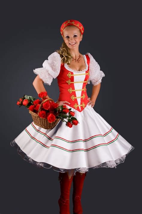 A Woman In A Red And White Dress Holding A Basket Full Of Roses Posing
