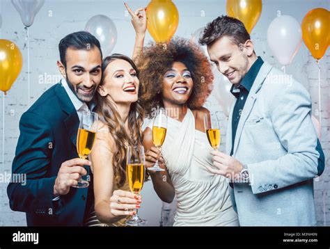 Group of party people celebrating with drinks a birthday or New years Stock Photo - Alamy