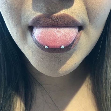 A Close Up Of A Woman S Tongue With Pink And White Powder On It