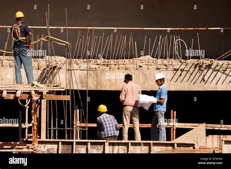 Construction Workers Work On A Building Site In The South Indian City