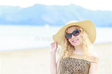 Beautiful Blonde Portrait On The Beach With Hat And Sunglasses Stock