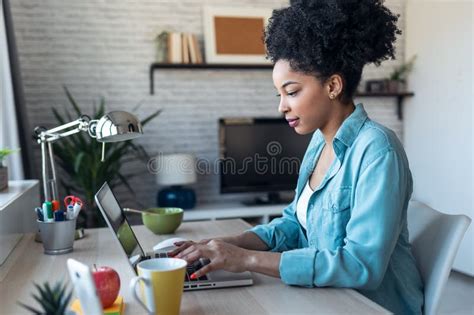 Beautiful Young Afro Business Woman Working With Laptop Sitting In The