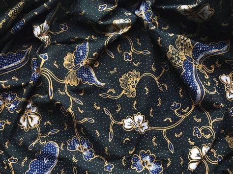 A Blue And Gold Patterned Fabric With Small White Flowers On The Bottom