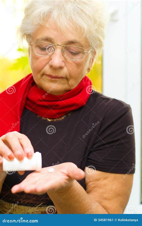 Senior Woman Holding A Pill In Her Hand Stock Image Image Of Closeup