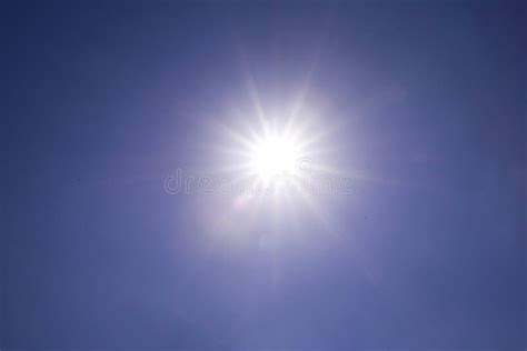 Clear Blue Sky Sun Light With Real Lens Flare Out Of Focus Stock Image