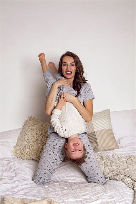 Mom And Son Playing On A Big White Bed Photograph By Elena Saulich