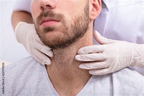 Doctor Performing Physical Exam Palpation Of The Thyroid Gland Photos Adobe Stock