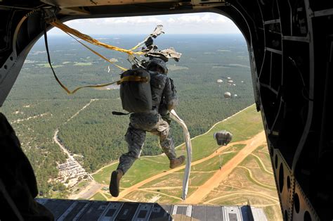 A Us Paratrooper Jumps From A Ch 47 Chinook Helicopter During