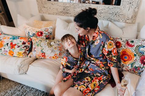 Mother And Daughter Sitting On Couch By Stocksy Contributor Leah