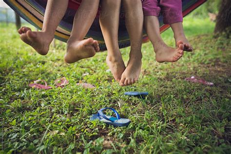 Barefoot Children On A Swing By Dejan Ristovski Stocksy United