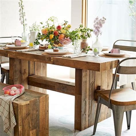 Farmhouse dining tables typically feature natural wood or distressed paint finishes. Emmerson® Reclaimed Wood Dining Table | west elm