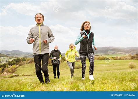 Group Of Seniors Running Outside On Green Hills Stock Image Image Of