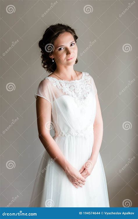 Portrait Picture Of A Shy Young Bride In A Simple Traditional White