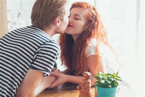 Couple Kissing At A Cafe By Stocksy Contributor Lumina Stocksy