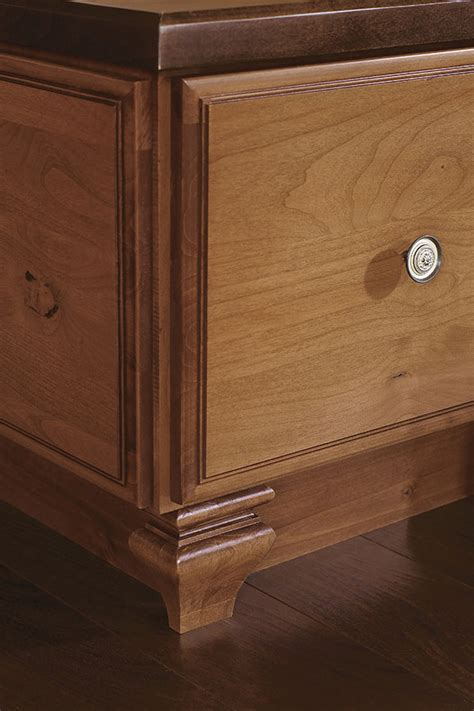 Just nail it to the cabinets so the floor can move. Toekick Tulip Cabinet Foot - Decora Cabinetry