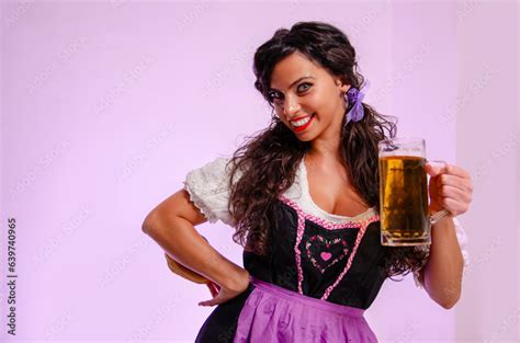 Cute Curly Hair Girl Oktoberfest Concept Holding Beer In Hands And Wearing Dirndl Dress