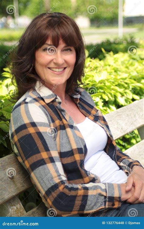 Beautiful Happy Mature Caucasian Woman Outside In The Park Stock Photo