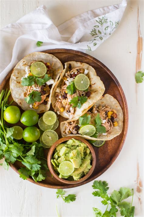 Shred the chicken with 2 forks. Crockpot Salsa Chicken Tacos - Lovely Little Kitchen