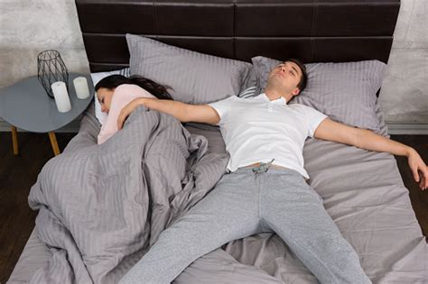 Young Male Sleeping In Free Fall Position With His Girlfriend Occupied