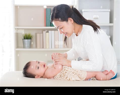 Baby Massage Asian Mother Massaging Baby Hands At Home Stock Photo Alamy