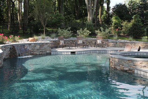 Custom Swimming Pool With Stacked Stone Walls And Spa Aqua Bello