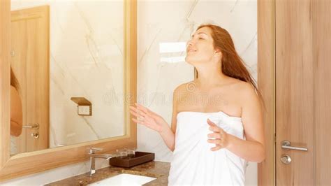 Attractive Brunette In White Towel Dances In Nice Bathroom Stock Photo