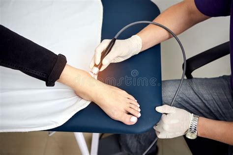 Feet Laser Therapy Physiotherapist Doctor Uses Laser Medical Equipment