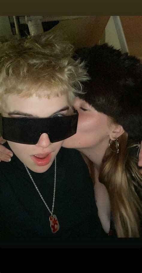 Two People Wearing Blindfolds And One Is Kissing The Other S Cheek With