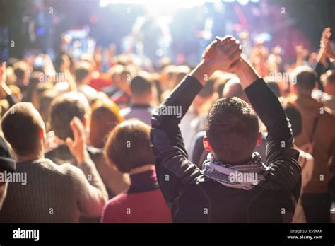 A Concert Crowd Of People Applauds The Artist On Stage Stock Photo Alamy