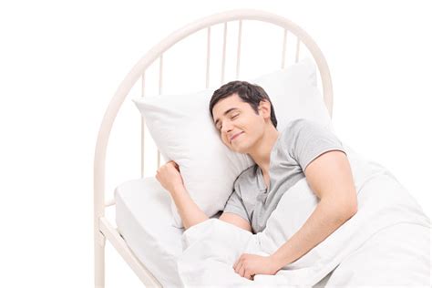 Carefree Young Man Sleeping In A Comfortable Bed Stock Photo Download